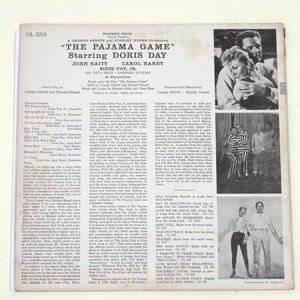 May include: A black and white photograph of Doris Day and Eddie Foy Jr. from the musical "The Pajama Game". The photo is from the back cover of a Warner Bros. record album. The album cover also includes the title of the musical, the names of the stars, and the names of the producers.