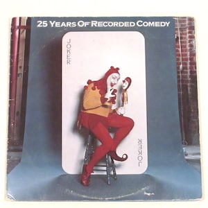 May include: A vintage vinyl record album cover featuring a jester in a red and yellow costume holding a puppet. The album cover is titled "25 Years of Recorded Comedy" and features the word "Joker" written on the card behind the jester.