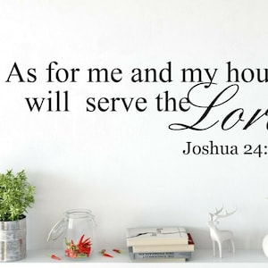 May include: A black wall decal with the text "As for me and my house we will serve the Lord Joshua 24:15". The dimensions are 57cm wide and 18cm high. Decorative items, including plants and books, are on a shelf below.