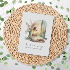 May include: A watercolor illustration of a lantern, books, and flowers in front of a window. The text "THANK YOU for being a great teacher" is written below the image.