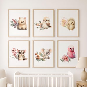May include: Six framed watercolour prints showcasing Australian animals: a wombat, kookaburra, hedgehog, sugar glider, koala, and a pink galah. Each animal is depicted with floral and botanical details, ideal for a nursery or children's room.