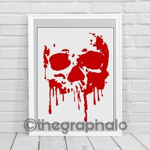 May include: A framed print of a red skull with dripping blood. The skull is on a white background.