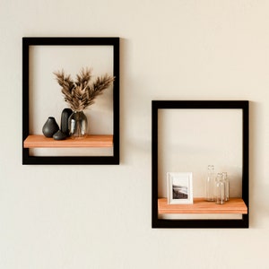 Wall shelf with metal frame Modern shelf with frame as wall decoration