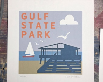 May include: A minimalist illustration of Gulf State Park in a muted color palette. The image features a sailboat, a house on stilts, a cloud, and seagulls. The text "GULF STATE PARK" is in orange and the text "2020 MIKE PURCELL" is in gray.