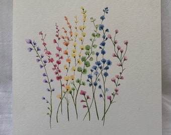 May include: Watercolor painting of colorful wildflowers in shades of purple, pink, orange, yellow, green, and blue. The flowers are depicted with delicate brushstrokes on a textured, off-white paper, creating a vibrant and naturalistic floral artwork.