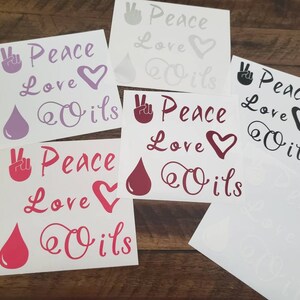 May include: Five white sticker sheets with the text "Peace Love Oils" in various colors and fonts. Each sheet features a peace sign, a heart, and a drop of oil.