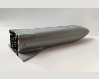 May include: A 3D printed model of a spacecraft with a silver finish and a black engine with five nozzles.