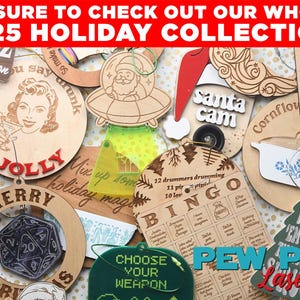 May include: A collection of wooden holiday ornaments with various designs, including a Santa in a UFO, a retro woman, and a bingo card. The ornaments feature text like "Merry Christmas" and "Choose Your Weapon". The top banner reads "2025 Holiday Collection!"