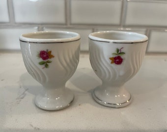 A pair of vintage porcelain single egg cups, relief fluting detail with roses, farmhouse kitchen