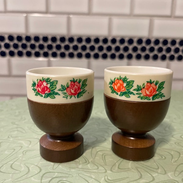 A pair of vintage wood and pastic egg cups, hand painted, single egg cups, floral motif, wooden base