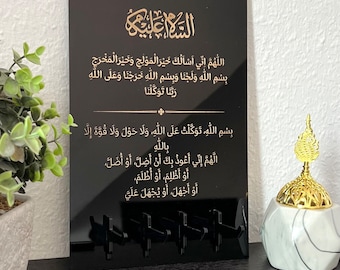 May include: Black acrylic plaque with gold Arabic calligraphy. The text reads "Assalamu alaykum" and includes a prayer for safe travel.