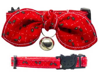 May include: Red cat collar with a bow tie and a bell. The bow tie has a holly pattern. The collar is adjustable and has a safety breakaway buckle.