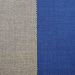 May include: Close-up of two fabric swatches, one a light gray and the other a dark blue. The swatches are side-by-side and show the texture of the fabric.