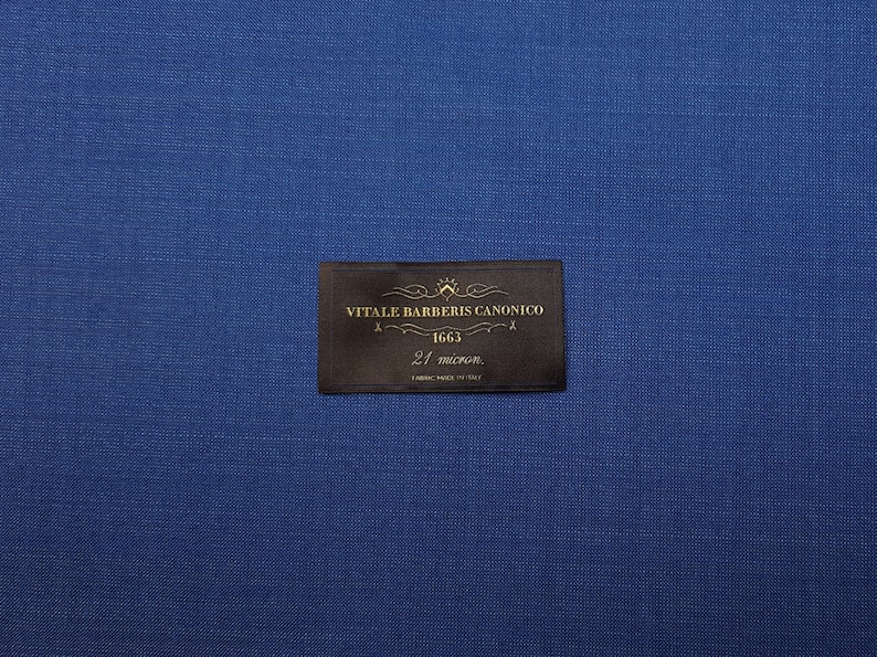 May include: A brown fabric label with gold text that reads "Vitale Barberis Canonico 1663 21 micror. Fabric Made in Italy".