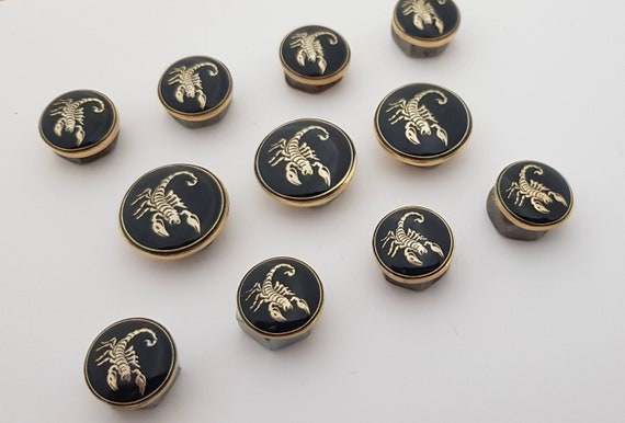Metal blazer scorpio sign shank buttons set. In gold and nickel on deep-blue enamel ground , high resolution, perfect quality, made in Italy