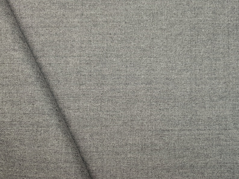May include: Close-up of a gray textured fabric with a subtle woven pattern.