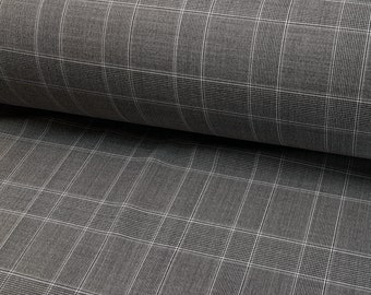 May include: Close-up of a gray and white plaid fabric. The fabric has a subtle texture and a woven pattern.