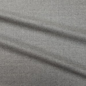 May include: Close-up of a gray textured fabric with a subtle diagonal pattern. The fabric has a smooth, soft feel and is slightly wrinkled.
