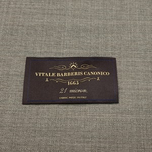 May include: A brown fabric label with gold text that reads "VITALE BARBERIS CANONICO 1663 21 micron. FABRIC MADE IN ITALY".