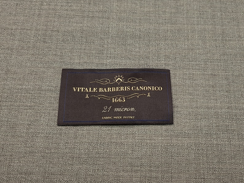 May include: A brown fabric label with gold text that reads "VITALE BARBERIS CANONICO 1663 21 micron. FABRIC MADE IN ITALY".