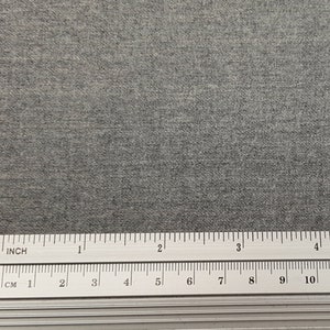 May include: A close-up of a gray, textured fabric with a ruler measuring 12 inches or 30.48 centimeters.