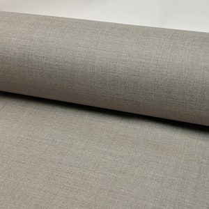 May include: Close-up of a gray textured fabric. The fabric has a subtle woven pattern.