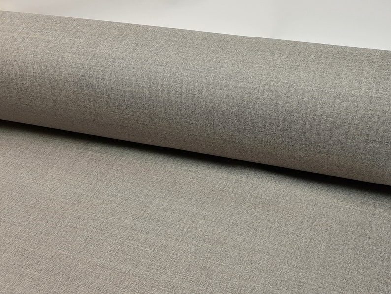 May include: Close-up of a gray textured fabric. The fabric has a subtle woven pattern.