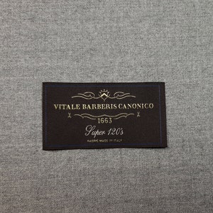 May include: A black fabric label with gold text that reads "VITALE BARBERIS CANONICO 1663 Super 120's FABRIC MADE IN ITALY"