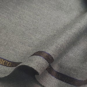 May include: Gray fabric with a brown and blue label that reads "Ermenegildo Zegna Super 120's Flan"