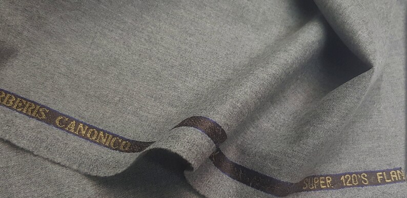 May include: Gray fabric with a brown and blue label that reads "Ermenegildo Zegna Super 120's Flan"