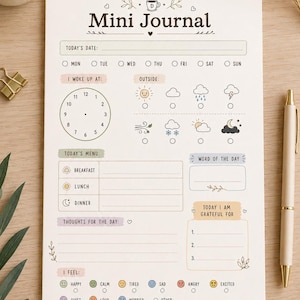 May include: A "Daily Mini Journal" on a light beige paper, with sections for date, time, weather, menu, thoughts, and feelings. Includes a pen, paper clips, and a cup of coffee. The journal is designed for daily reflection.