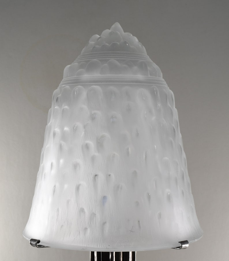 May include: A white frosted glass lampshade with a textured, ribbed design. The shade is bell-shaped and has a rounded top.