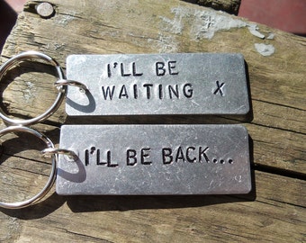 May include: Two silver keychains with the text "I'll be waiting x" and "I'll be back..." engraved on them.