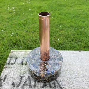 May include: A copper pipe vase with a base made of clear resin filled with colorful stones and glitter.