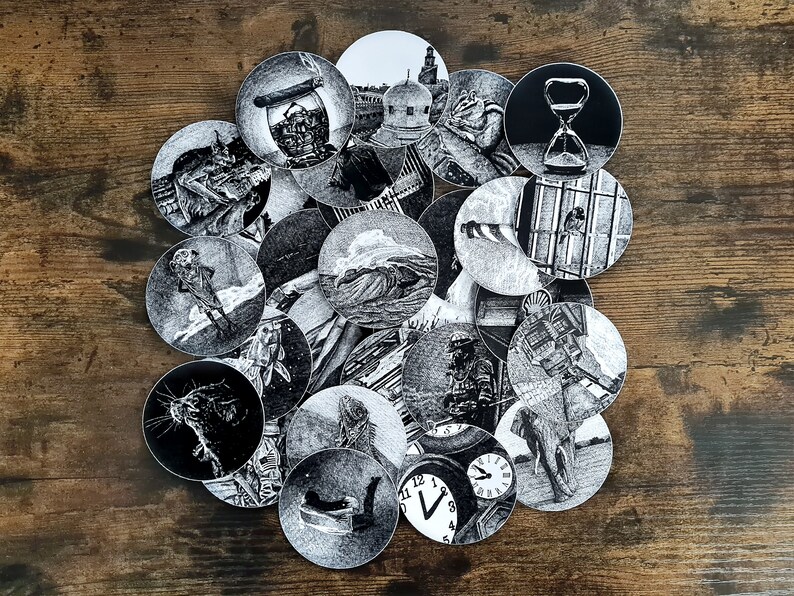 May include: A collection of black and white circular stickers featuring detailed illustrations. The images include an hourglass, a well, a clock, an elephant, and other surreal scenes. The stickers are arranged on a wooden surface.