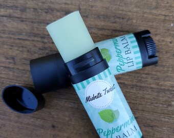 May include: Two peppermint lip balm tubes with a mint green and white label. The label says "Peppermint Lip Balm" and "Midnite Twist".