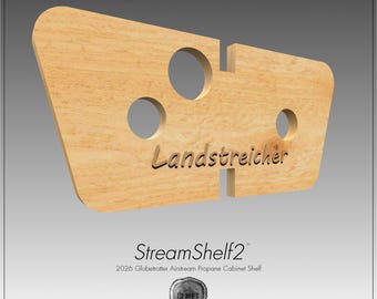 May include: A light-colored wooden shelf with a trapezoidal shape, featuring three circular cutouts and two vertical slots. The word Landstreicher is engraved on the front. Below, the text reads StreamShelf2 2026 Globetrotter Airstream Propane Cabinet Shelf.