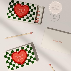 Puede incluir: Caja de cerillas con un patrón de cuadros verdes y blancos, con un corazón rojo con los nombres "Dergia & Maria". La caja está abierta, revelando cerillas. También se ve una segunda caja y cerillas sueltas. El texto "29 June 2025" está en una caja.