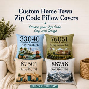 May include: Four square pillow covers featuring custom zip codes, city names, and regional illustrations. The designs include a Key West lighthouse, a Grapevine cityscape, a Santa Fe adobe building, and a snowy Red River mountain landscape.