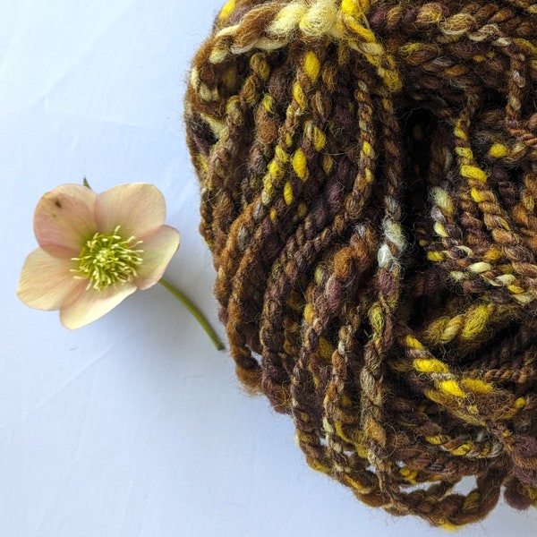 Mix brown and yellow handspun 2ply art yarn for weaving textile and fiber crafts.