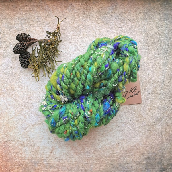 Green and blue handspun Christmas art yarn for weaving,textile and fiber crafts.