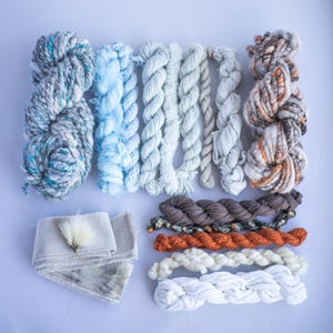 Grey blue yarn bundle for weaving, textile and fibre crafts.