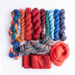 Red and blue yarn bundle for weaving, textile and fibre crafts.