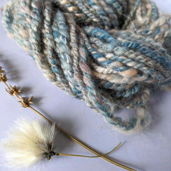 Beige and teal wool and lama handspun 2ply art yarn for weaving, textile and fiber crafts.