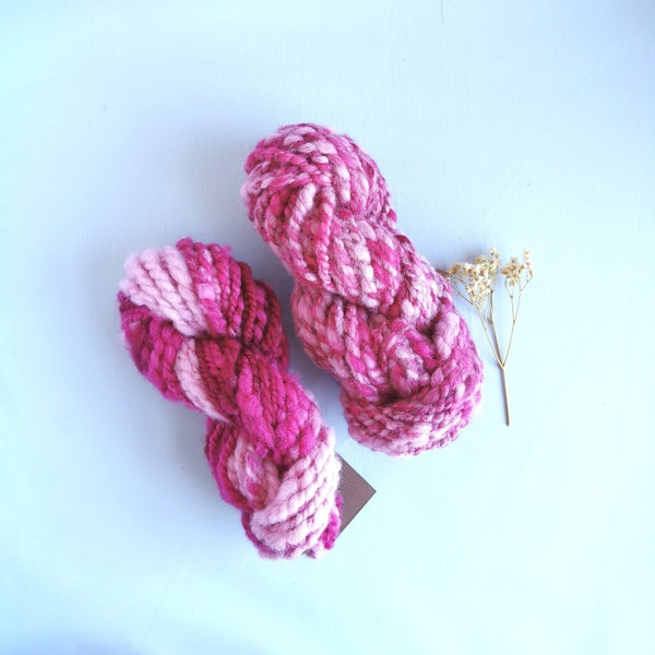 Pink and hot pink ombre and shine handspun art yarn for weaving, textile and fiber crafts.