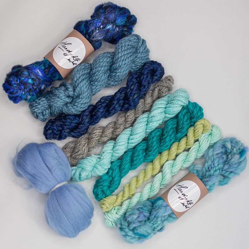 green and rust tone handspun art yarn bundle .Weaving textile fiber pack. Blue,teal