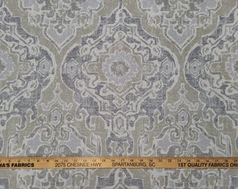 May include: Close-up of a fabric with a repeating damask pattern in shades of gray, beige, and off-white. The design features stylized floral and geometric shapes. A wooden ruler is at the bottom.