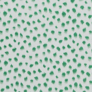 May include: White fabric with a repeating pattern of green, irregular, brushstroke-like shapes. The green shapes are scattered across the surface, creating a textured, organic design. The fabric appears to be a cotton or linen blend.