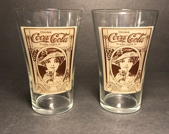 Lovely Victorian lady sipping the Elixir of Vitality, Pair of reproduction Coke Flair 16 ounce glasses, Tan and Brown art