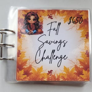 May include: A fall savings challenge tracker with a cartoon girl and autumn leaves. The tracker has a goal of $650.